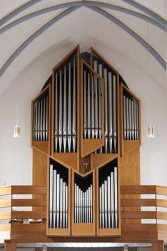 Moderne Orgel mit hellem Holzgehäuse.